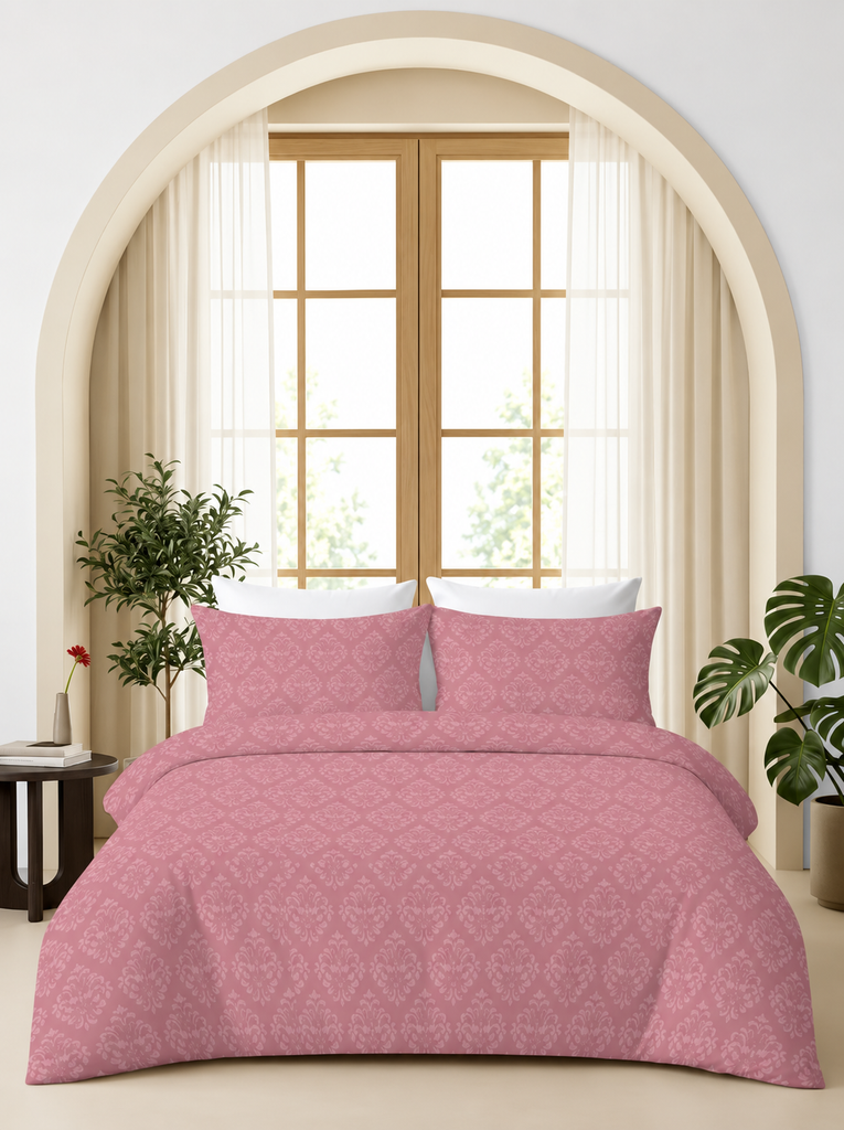Pink damask embossed bedsheet set styled on a bed in a bright modern bedroom.
